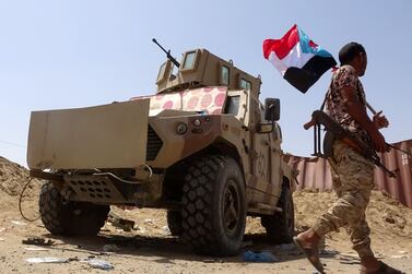 A fighter loyal to Yemen's Southern Transitional Council holds the group’s flag in the southern Abyan province on May 18, 2020, following a three-hour ceasefire deal between pro-government troops and separatist forces. AFP  