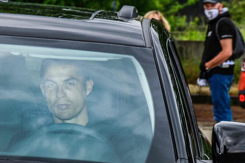 Juventus' Portuguese forward Cristiano Ronaldo arrives in his car to resume training after a quarantine on May 19, 2020 at the club's Continassa training ground in Turin. AFP