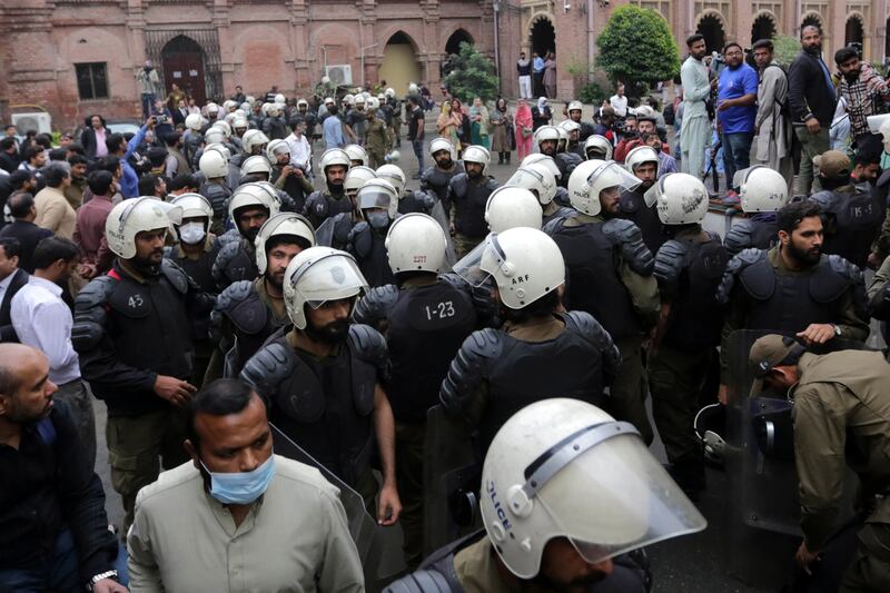 Riot police on guard outside Lahore High Court on Friday as Imran Khan appeared to request protective bail. EPA 
