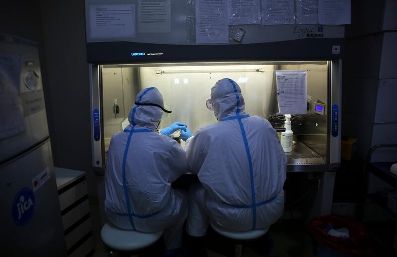 Afghan lab technicians test samples at the Afghan-Japan Communicable Disease Hospital.