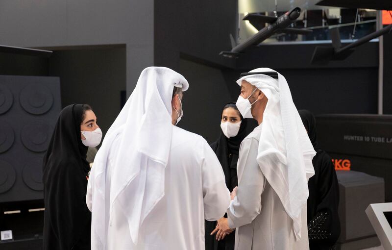 Sheikh Mohamed bin Zayed, Crown Prince of Abu Dhabi and Deputy Supreme Commander of the Armed Forces, discusses an exhibit.