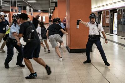 HONG KONG, CHINA - SEPTEMBER 5: A police officer holds up pepper spray as he attempts to disperses protesters out of the platform at Po Lam Station on September 5, 2019 in Hong Kong, China. Pro-democracy protesters have continued demonstrations across Hong Kong since 9 June against a controversial bill which allows extraditions to mainland China, as the ongoing protests, many ending up in violent clashes with the police, have surpassed the Umbrella Movement from five years ago and become the biggest political crisis since Britain handed its onetime colony back to China in 1997. Hong Kong's embattled leader Carrie Lam announced the formal withdrawal of the controversial extradition bill on Wednesday, meeting one of protesters' five demands after 13 weeks of demonstrations. (Photo by Anthony Kwan/Getty Images)