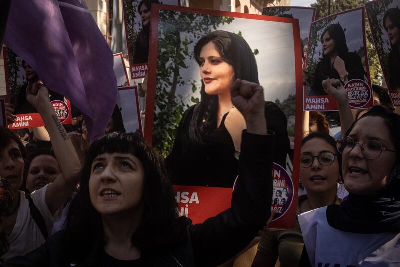Women hold signs and chant slogans during a protest over the death of Iranian Mahsa Amini outside the Iranian Consulate on September 29 in Istanbul, Turkey. Getty