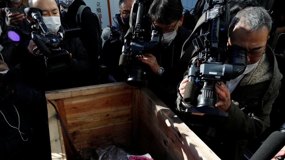 A 211-kilogram bluefin tuna that was auctioned for about 16. 9 million Japanese yen or around 145,290 dollars and bought jointly by Michelin-starred sushi restaurant operator Onodera Group and wholesaler Yamayuk is surrounded by media as it arrived at a sushi restaurant after the first tuna auction of the New Year in Tokyo, Japan January 5, 2022.   REUTERS / Issei Kato