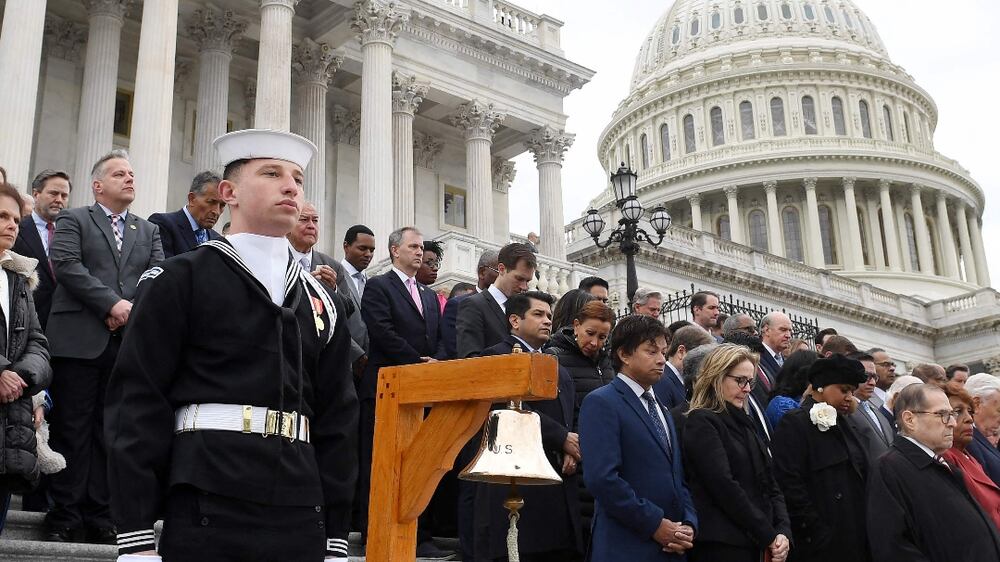 US Democratic Representative of New York, Hakeem Jeffries (R), and a bipartisan group of lawmakers observe a moment of silence on the east front steps of the US Capitol to honor the officers who lost their lives in the attack on the Capitol, on the second anniversary of the January 6, 2021 attack in Washington, DC, on January 6, 2023.  (Photo by OLIVIER DOULIERY  /  AFP)