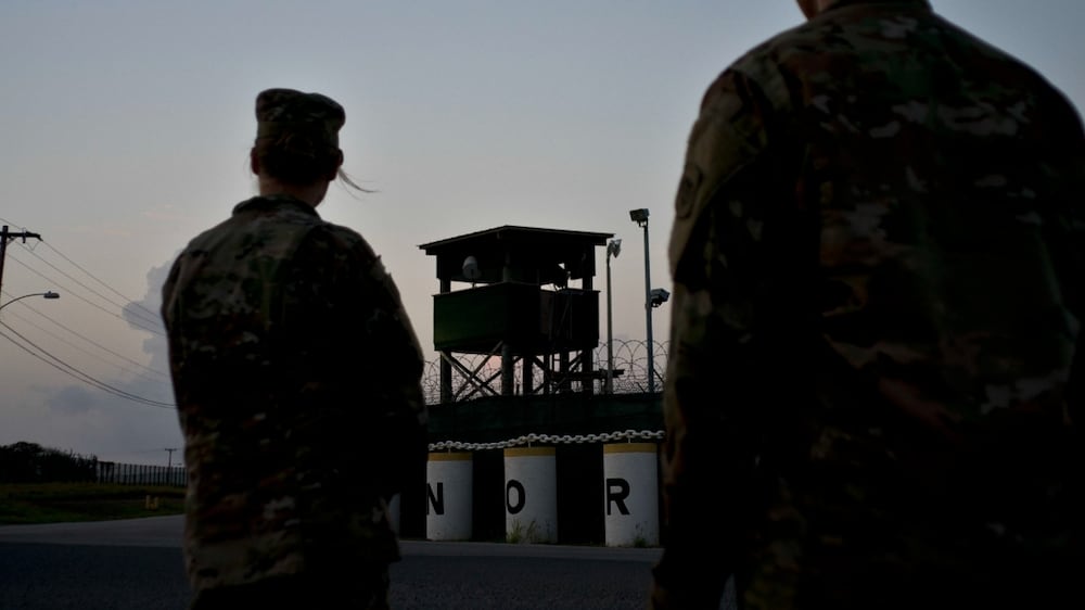 FILE - In this June 5, 2018 photo, reviewed by U. S.  military officials, troops stand guard outside Camp Delta at the Guantanamo Bay detention center, in Cuba.  The 20th anniversary of the first prisoners' arrival at the Guantanamo Bay detention center is on Tuesday, Jan.  11, 2022.  There are now 39 prisoners left.  At its peak, in 2003, the detention center held nearly 680 prisoners.  (AP Photo / Ramon Espinosa, File)