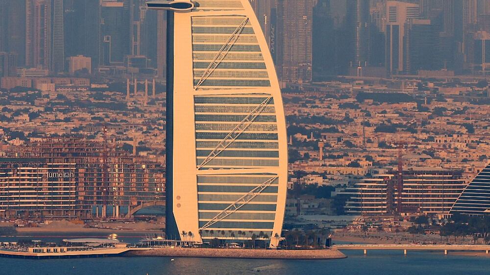 A picture taken from "the View at Palm " shows the the Burj al-Arab and a view of the Gulf emirate of Dubai on January 10, 2022.  (Photo by Giuseppe CACACE  /  AFP)