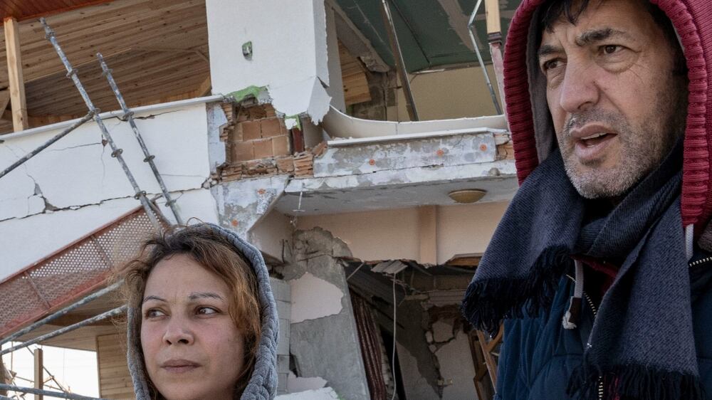 Yasmina and Andar stand in front of their destroyed home in Antakya, Turkey on 10 February 2023, four days after catastrophic earthquake. Matt Kynaston / The National
