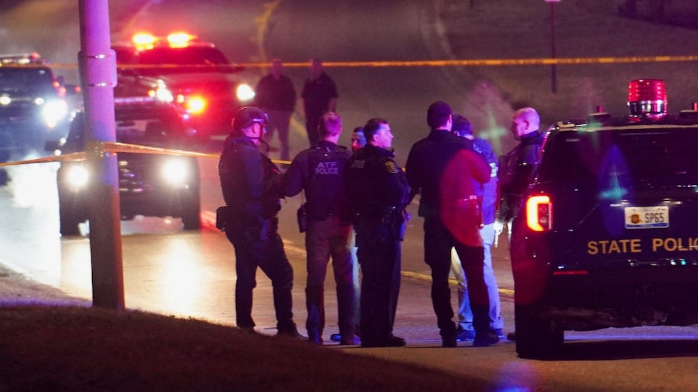 Police officers surround a scene where the suspect was located as they respond to a shooting at Michigan State University in East Lansing, Michigan, U. S. , February 14, 2023.    REUTERS / Dieu-Nalio Chery