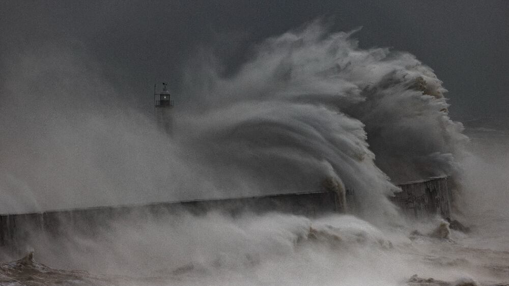 NEWHAVEN, ENGLAND - FEBRUARY 18: Storm waves batter the Newhaven breakwater and Lighthouse on February 18, 2022 in Newhaven, England. The Met Office has issued two rare, red weather warnings for the South and South West of England today as Storm Eunice makes landfall. Much of the rest of the UK is under amber and yellow warnings with winds up to 100 mph, rain and snow expected. This is the worst storm to hit the UK for three decades.  (Photo by Dan Kitwood / Getty Images)