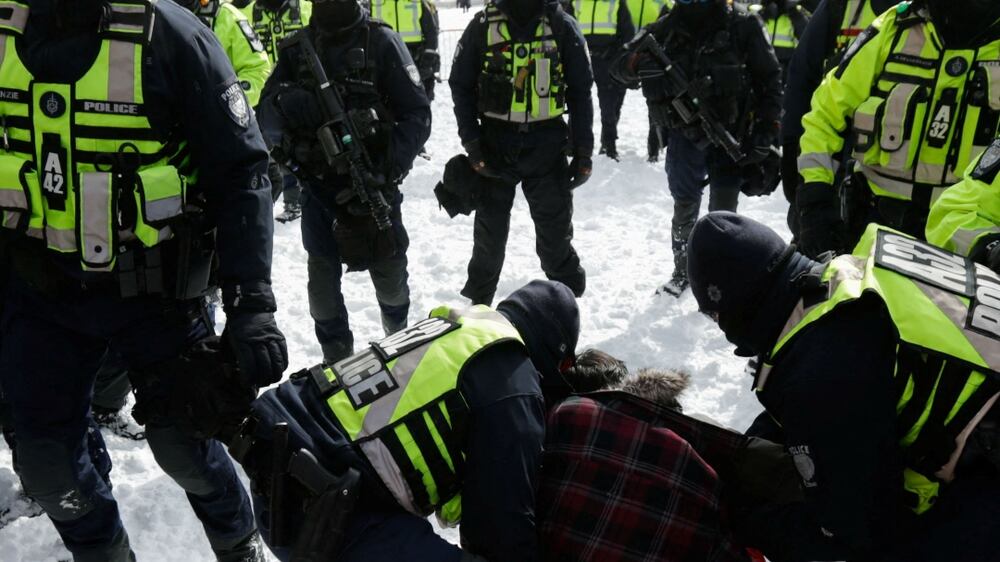 Police officers detain a man, as truckers and supporters continue to protest coronavirus disease (COVID-19) vaccine mandates, in Ottawa, Ontario, Canada, February 18, 2022.  REUTERS / Carlos Osorio
