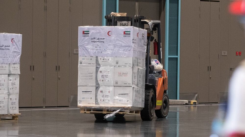 Palettes of boxes with  different kind of food items, blankets and hygiene products are being taken to the loading area at Emirates Red Crescent “Bridges of Goodness” campaign in support of quake-ravaged  Turkiye and Syria at the South Hall , Dubai Exhibition Centre at Expo City.  Leslie Pableo for The National