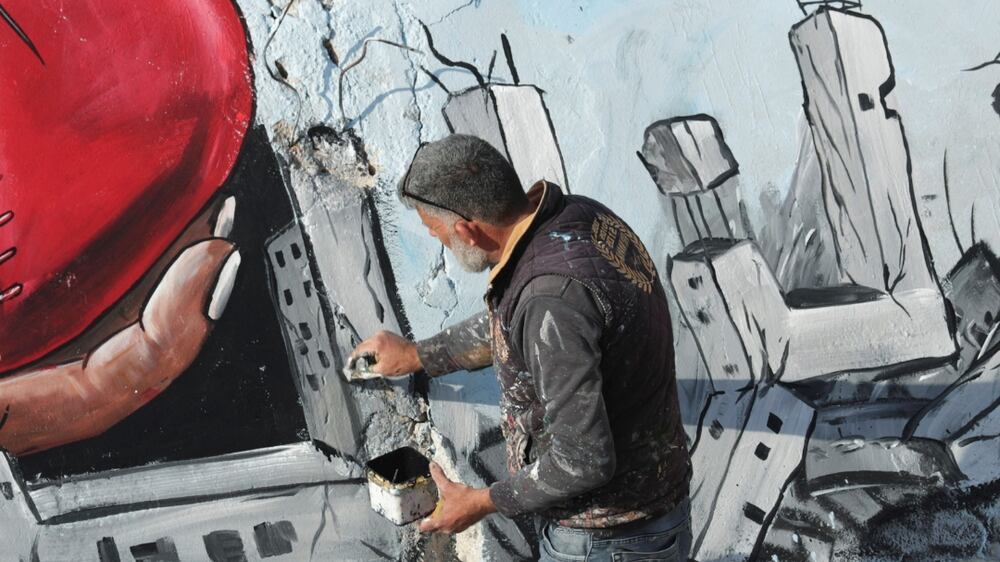 Syrian artists paint mural on rubble in Jandaris