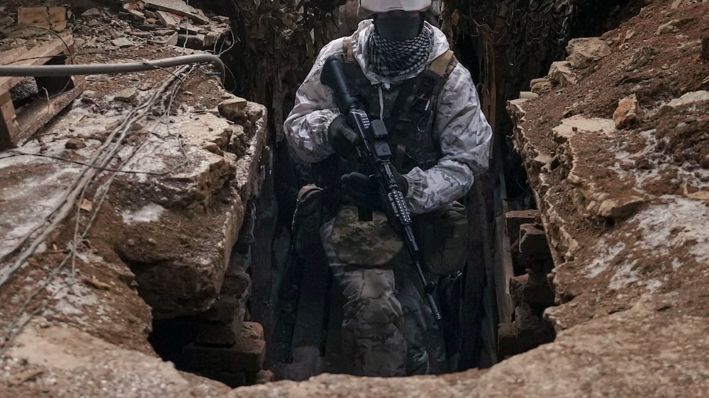A Ukrainian serviceman walks in a trench at a frontline position outside Avdiivka, Donetsk region, eastern Ukraine, Saturday, Feb.  5, 2022.  The French president and the German chancellor will head to Moscow and Kyiv in the coming weeks, adding to diplomatic efforts to try to deter Russian President Vladimir Putin from launching an invasion of Ukraine and find a way out of the growing tensions.  (AP Photo / Vadim Ghirda)