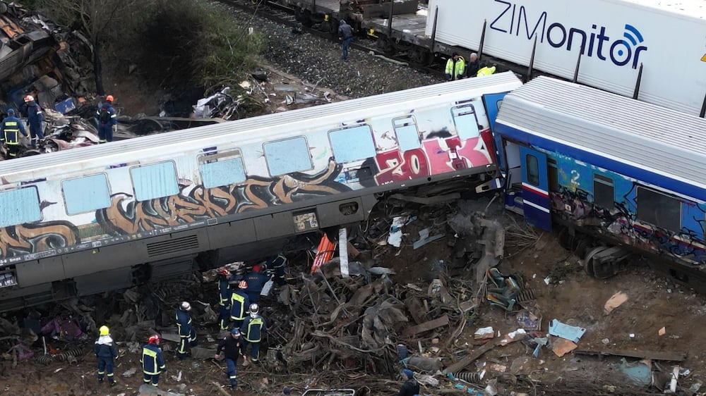 Firefighters and rescuers operate after a collision in Tempe near Larissa city, Greece, Wednesday, March 1, 2023.  A train carrying hundreds of passengers has collided with an oncoming freight train in northern Greece, killing and injuring dozens passengers.  (AP Photo / Vaggelis Kousioras)