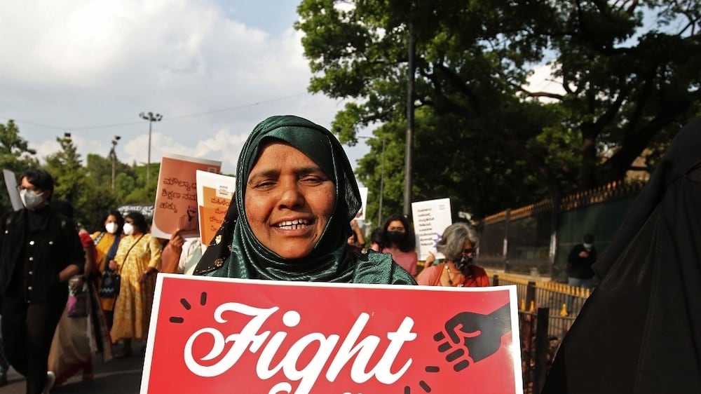 Women from various organizations hold placards during a protest for dignity, autonomy, plurality and peace ahead of International Womenâ€™s Day in Bangalore, India, 06 March 2022.  About a hundred women gathered to condemn the growing harassment, discrimination and violence on Muslim women amid the ongoing row over the wearing of hijab (headscarf) by Muslim girls in schools and colleges of the country.   EPA / JAGADEESH NV