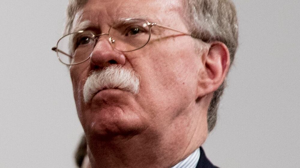 FILE - National Security Adviser John Bolton attends a meeting with President Donald Trump as he meets with Indian Prime Minister Narendra Modi at the G-7 summit in Biarritz, France, Aug.  26, 2019.  The Justice Department says an Iranian operative has been charged in a plot to murder former Trump administration national security John Bolton.   (AP Photo / Andrew Harnik, File)