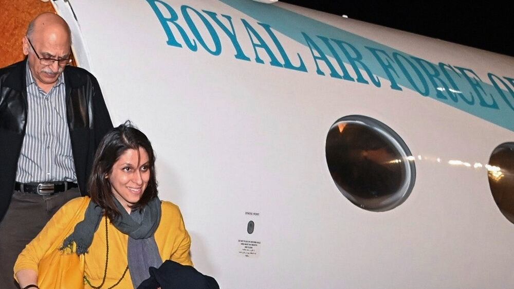 In this photo released by the Oman News Agency, Nazanin Zaghari-Ratcliffe, front, and Anoosheh Ashoori, who were freed from Iran, arrive in Muscat, Oman, Wednesday, March 16, 2022.  The two British citizens who had been jailed in Iran for more than five years, charity worker Zaghari-Ratcliffe and retired civil engineer Ashoori, returned home to their families' hugs and tears Thursday after the U. K.  settled a decades-old debt to Iran.  (Oman News Agency via AP)