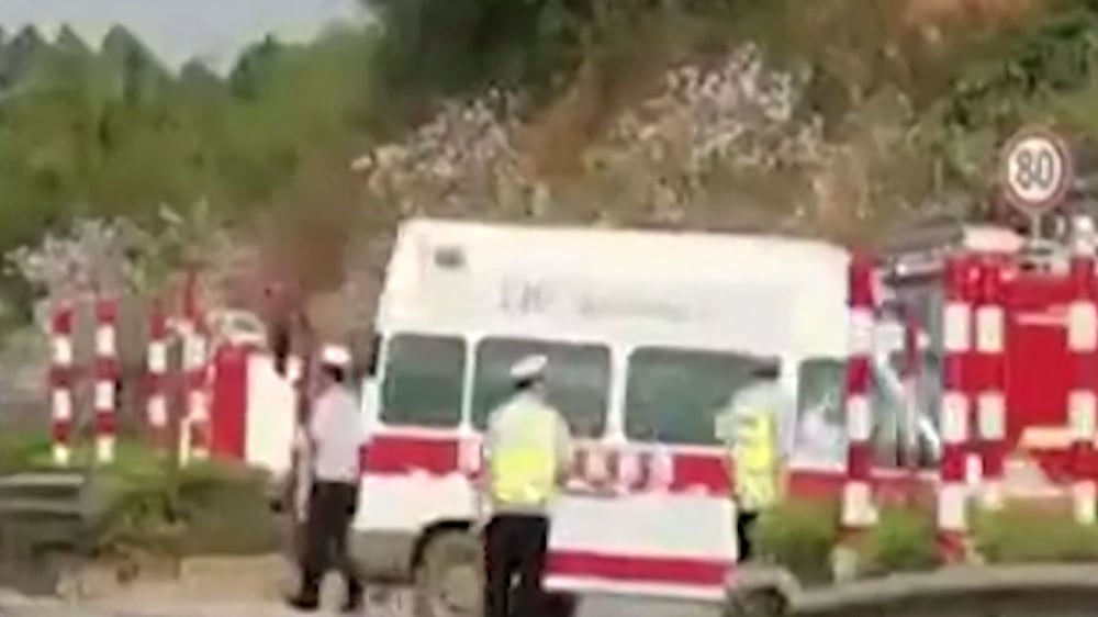 This screen grab taken from video from The Paper and received via AFPTV on March 21, 2022 shows ambulances turning off onto a side road upon arrival after a China Eastern reportedly crashed in Teng County in Wuzhou City, Guangxi province.  - The China Eastern passenger jet carrying 132 people "crashed" in southwest China, the state flight regulator confirmed on March 21, with the number of casualties unknown according to the country's state broadcaster.  (Photo by various sources  /  AFP)  /  RESTRICTED TO EDITORIAL USE