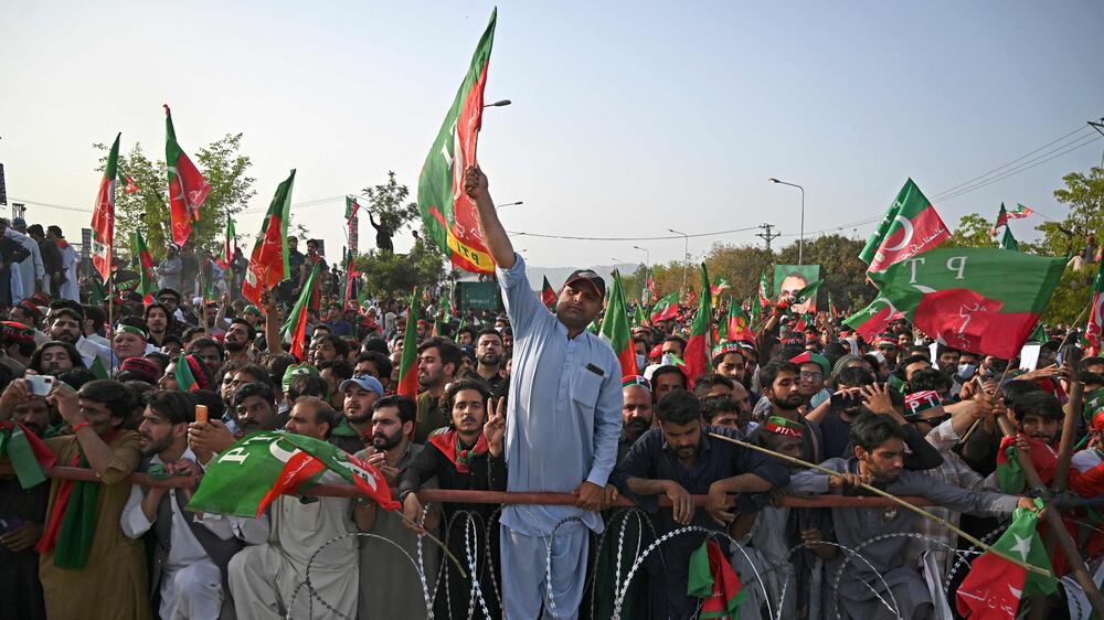 Supporters of ruling Pakistan Tehreek-e-Insaf (PTI) party attend a rally being addressed by Pakistan's Prime Minister Imran Khan, in Islamabad on March 27, 2022.  (Photo by Aamir QURESHI  /  AFP)