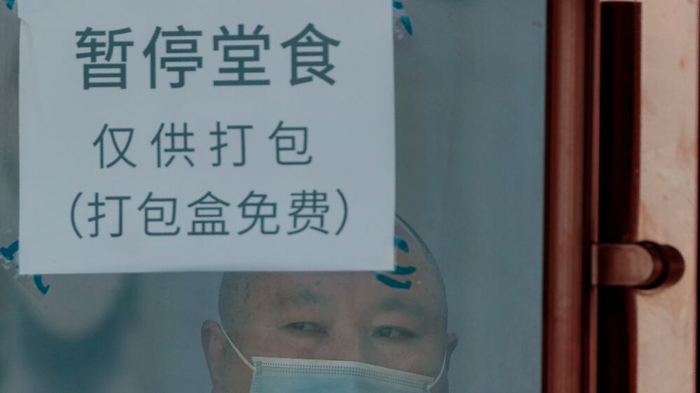 A quarantined man looks through a shop window in a locked down shop, in Shanghai, China, 29 March 2022.  On 29 March 2022, in China, there were 96 new locally transmitted COVID-19 cases and 4,381 asymptomatic infections, according to the National Health Commission.  Shanghai city imposed a strict lockdown amid the COVID-19 resurgence.  A complete lockdown hits the two biggest areas in the city, divided by the Huangpu River.  East of the Huangpu River,  in the Pudong area the lockdown started on 28 March and lasts until 01 April, while in the western area, in Puxi, people will have a lockdown from 01 April to 05 April.   EPA / ALEX PLAVEVSKI