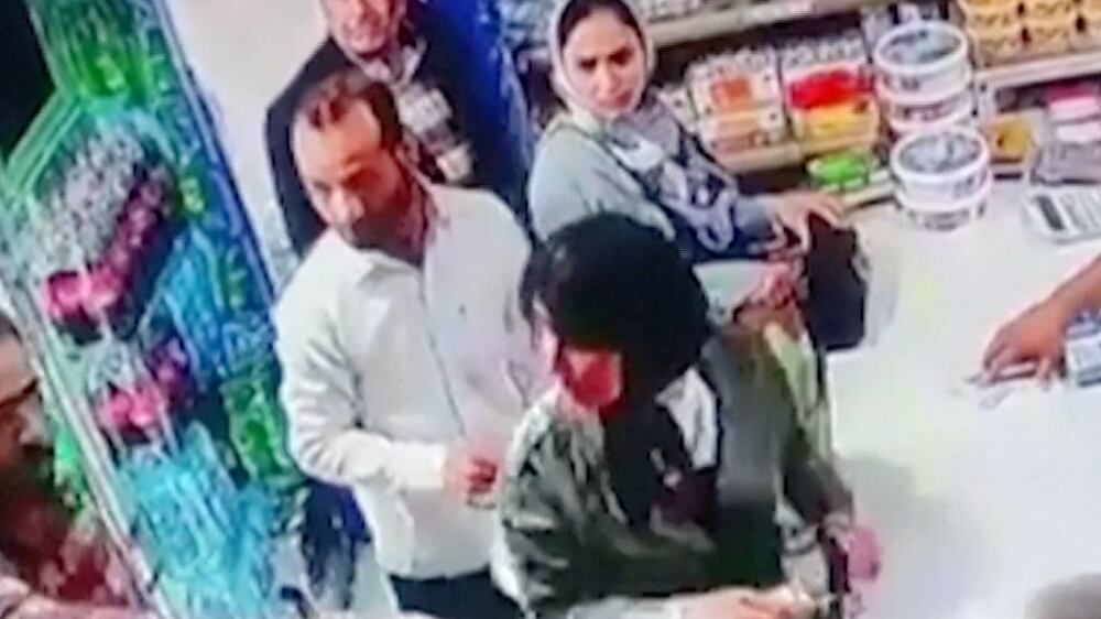 Screengrab from Reuters video showing a man in Iran throwing yogurt on two women for not covering their hair