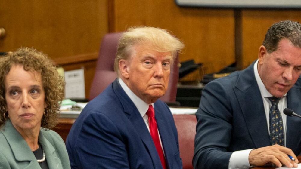 Former US president Donald Trump (3rd R) appears in court at the Manhattan Criminal Court in New York on April 4, 2023.  - Former US president Donald Trump arrived for a historic court appearance in New York on Tuesday, facing criminal charges that threaten to upend the 2024 White House race.  (Photo by Steven HIRSCH  /  POOL  /  AFP)