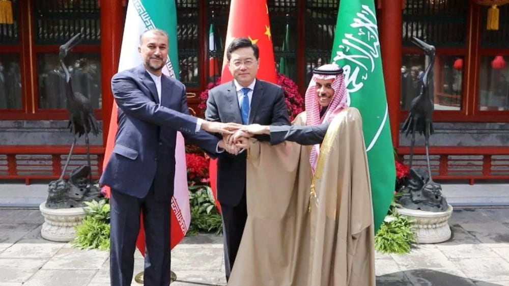 Iranian Foreign Minister Hossein Amir-Abdollahian and Saudi Arabia's Foreign Minister Prince Faisal bin Farhan Al Saud and Chinese Foreign Minister Qin Gang shake hands during a meeting in Beijing, China, April 6, 2023.  Iran's Foreign Ministry / WANA (West Asia News Agency) / Handout via REUTERS ATTENTION EDITORS - THIS PICTURE WAS PROVIDED BY A THIRD PARTY