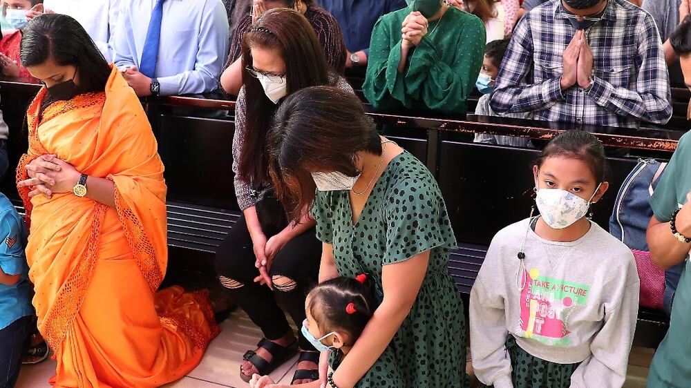 People during the Easter Sunday mass held at St. Mary's Catholic Church in Dubai. Pawan Singh / The National