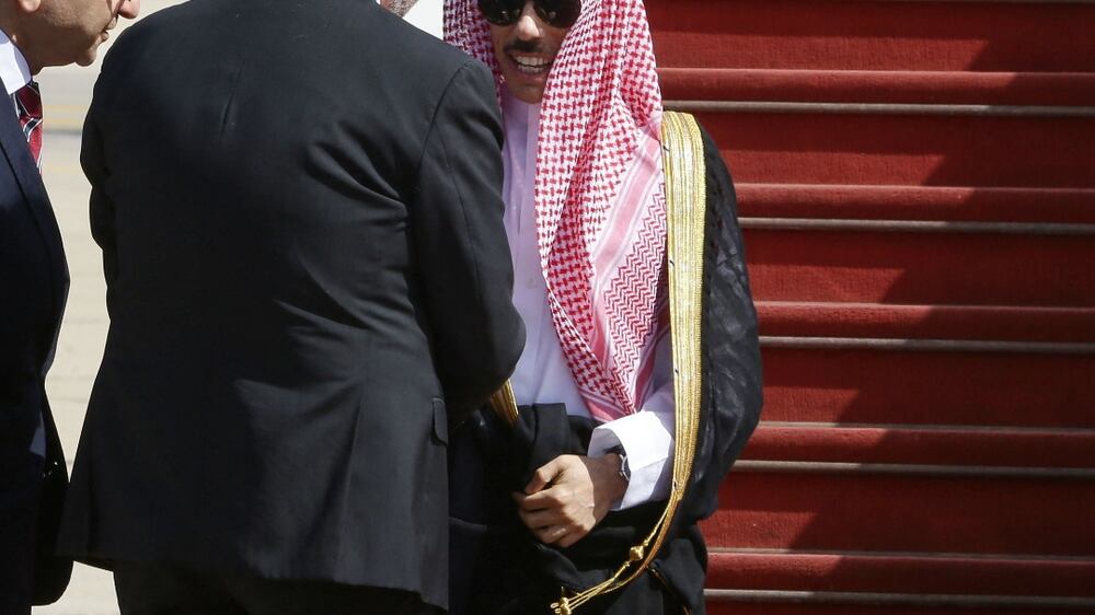 Syrian State Minister for Presidential affairs Mansur Azzam (C) welcomes Saudi Foreign Minister Faisal bin Farhan at Damascus airport, on April 18, 2023.  - Bin Farhan's is the first visit to Syria's capital by a Saudi official since the start of the country's civil war in 2011.  (Photo by LOUAI BESHARA  /  AFP)