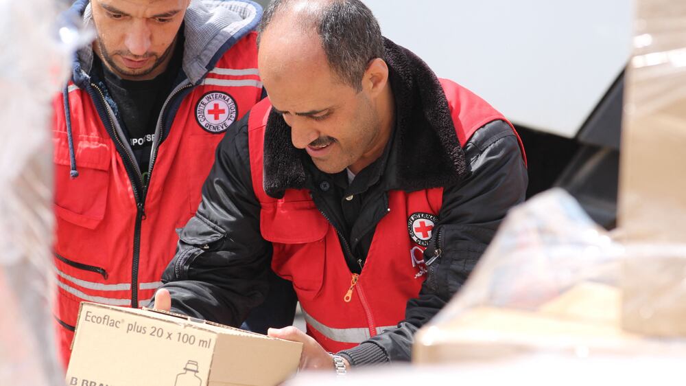 A handout picture released by the International Committee of the Red Cross (ICRC) on April 30, 2023, shows ICRC members preparing boxes of humanitarian aid in Amman, before loading it on a plane destined to Port Sudan.  - A first plane laden with humanitarian aid from the International Committee of the Red Cross landed in Sudan, where deadly clashes between rival generals' forces entered their third week.  (Photo by ICRC  /  AFP)  /  RESTRICTED TO EDITORIAL USE - MANDATORY CREDIT "AFP PHOTO  /  ICRC" - NO MARKETING NO ADVERTISING CAMPAIGNS - DISTRIBUTED AS A SERVICE TO CLIENTS