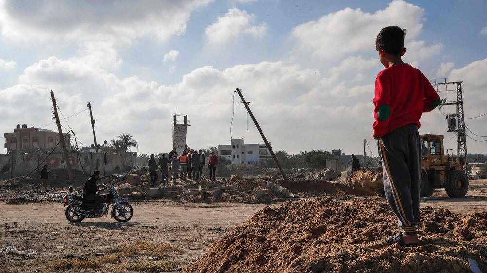 A Palestinian boy checks the site of an air strike targeting a military site in Deir al Balah, in the central Gaza Strip, on May 3, 2023, following a flare-up between the Israeli military and Gaza militants.  - The Israeli military conducted air strikes and traded fire with Gaza militants in a flare-up of violence following the death in Israeli custody of a Palestinian prisoner on hunger strike.  (Photo by ANAS BABA  /  AFP)