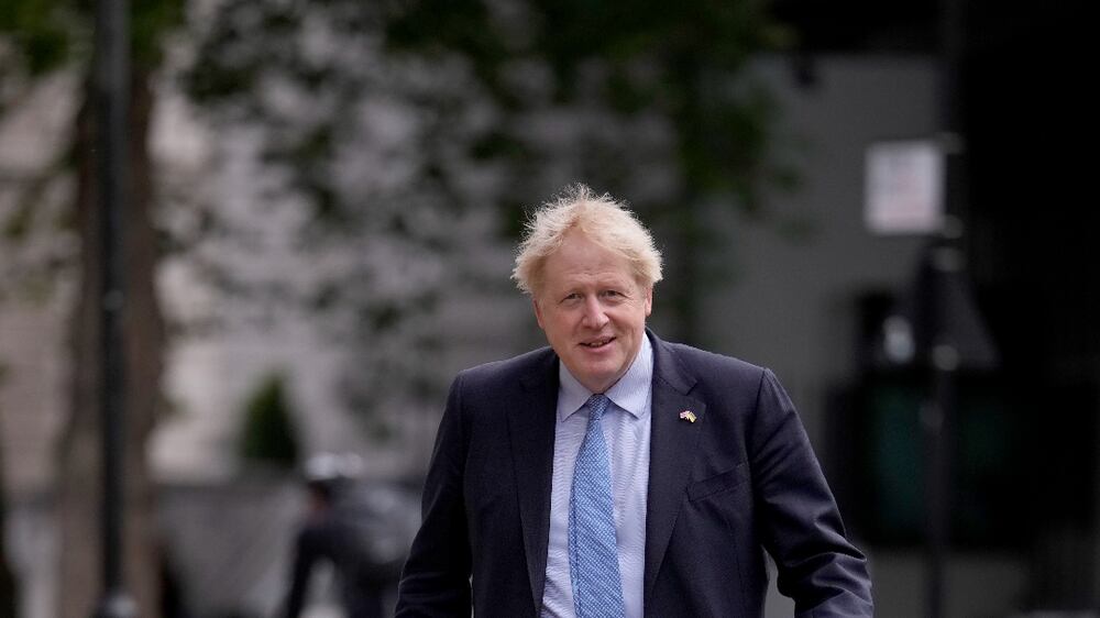 British Prime Minister Boris Johnson arrives with his dog Dilyn to vote at a polling station in London, for local council elections, Thursday, May 5, 2022.  (AP Photo / Matt Dunham)