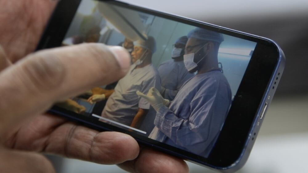 Dubai resident Dr Yasir Amin Latif showing videos on his phone when he treated wounded in Sudan