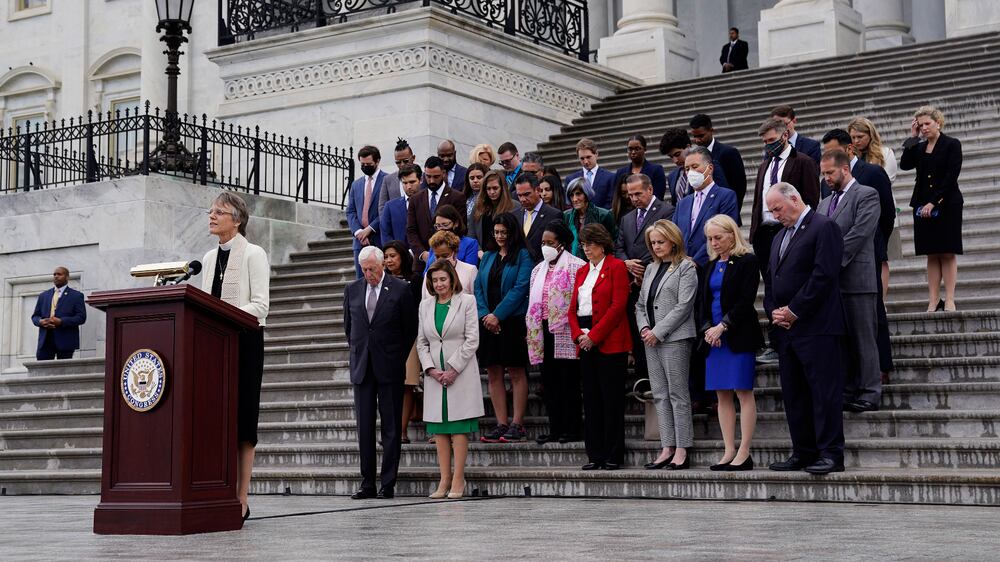 Rev.  Mariann Edgar Budde, the Bishop of Washington, speaks as Speaker of the House Nancy Pelosi (C) leads other lawmakers in a moment of silence for the 1,000,000 Americans who lost lives to Covid-19, outside the US Capitol in Washington, DC, USA, 12 May 2022.   EPA / WILL OLIVER