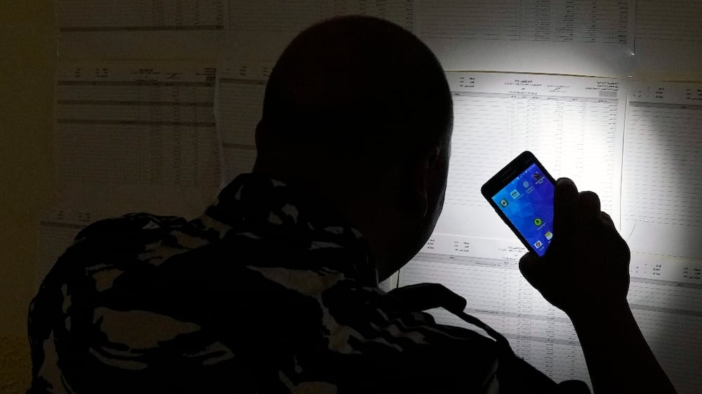 A policeman checks voters lists during parliamentary elections in Tripoli, Lebanon Saturday, May 14, 2022.  (AP Photo / Bilal Hussein)