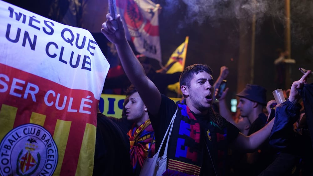 Barcelona fans celebrate in the street after their team won the Spanish La Liga championship by beating crosstown rivals Espanyol in Barcelona, Spain, Sunday May 14, 2023.  (AP Photo / Joan Mateu Parra)