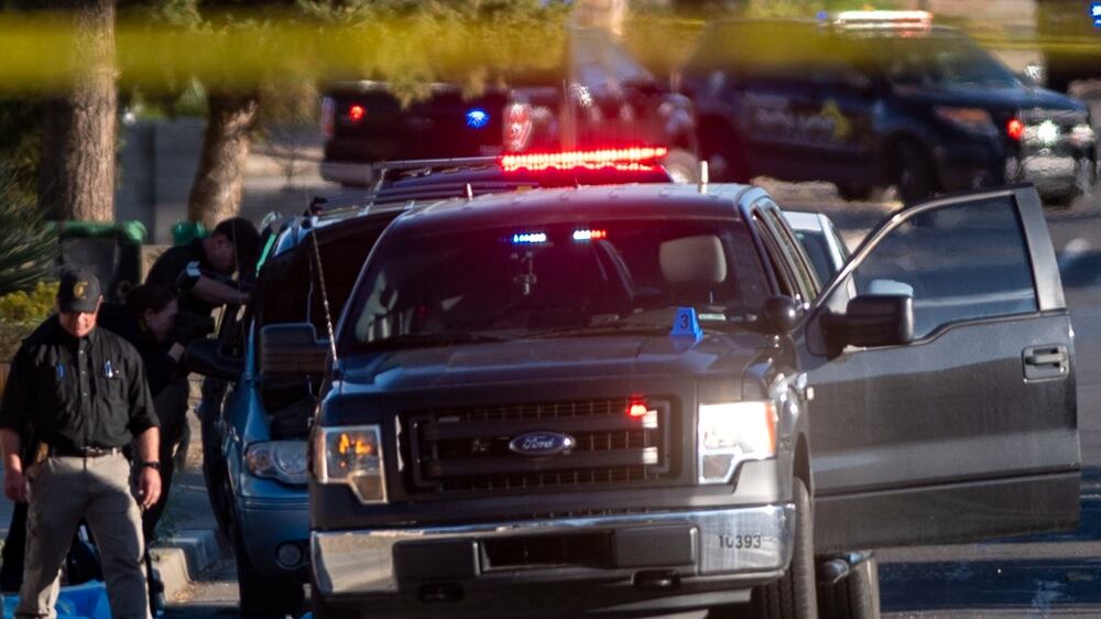 Law enforcement personnel investigate the scene of a shooting on North Dustin Avenue in Farmington, N. M. , Monday, May 15, 2023.  (Jon Austria / The Albuquerque Journal via AP)