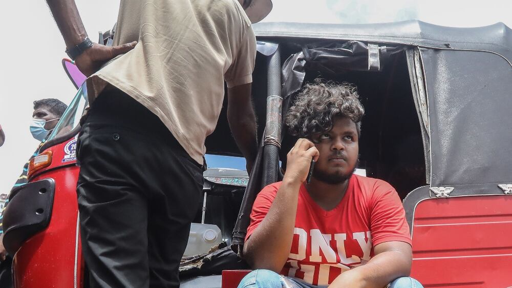 People wait to buy petrol at a gas station amid fuel shortage in Colombo, Sri Lanka, 17 May 2022. Â Protests have been rocking the country for weeks, calling for the resignation of the president over the alleged failure to address the worsening current economic crisis.  Sri Lanka faces its worst economic crisis in decades due to the lack of foreign exchange, resulting in severe shortages in food, fuel, medicine, and imported goods.   EPA / CHAMILA KARUNARATHNE