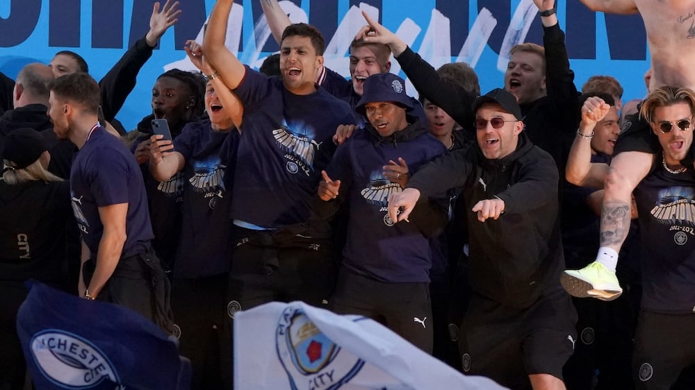 Manchester City's players attend an event for fans with members of the Manchester City football team following an open-top bus parade through Manchester, north-west England on May 23, 2022, to celebrate winning the 2021-22 Premier League title.  - Manchester City's latest Premier League title triumph established the champions as a burgeoning dynasty.  City's fourth title in five seasons is arguably the greatest achievement of Guardiola's glittering career as he found a way to hold off Liverpool's relentless challenge by one point.  (Photo by Oli SCARFF  /  AFP)