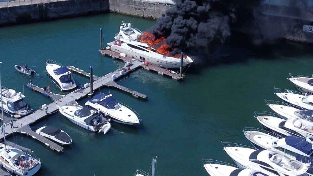 Thick black smoke rises from a fire on a yacht, at Torquay harbour in Torquay, Britain May 28, 2022.  Picture taken with a drone.  Mike Trower/Handout via REUTERS  THIS IMAGE HAS BEEN SUPPLIED BY A THIRD PARTY.  MANDATORY CREDIT.  NO RESALES.  NO ARCHIVES. 