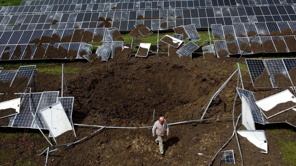 Vladimir Mihailovich, a solar plant manager, walks next to a crater after a shelling hit the station that was producing 2. 5 megawatts of power, amid Russia's attack on Ukraine, in the town of Merefa on the outskirts of Kharkiv, Ukraine May 28, 2022.  Picture taken with a drone.  REUTERS / Ivan Alvarado     TPX IMAGES OF THE DAY