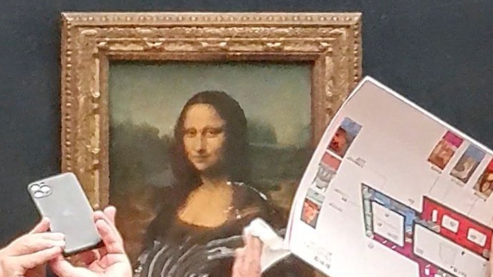 Climate protestor smears cream across Mona Lisa