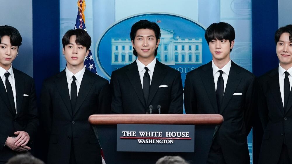 Members of the K-pop supergroup BTS from left, V, Jungkook, Jimin, RM, Jin, J-Hope, and Suga join White House press secretary Karine Jean-Pierre during the daily briefing at the White House, Tuesday, May 31, 2022, in Washington.  (AP Photo / Evan Vucci)