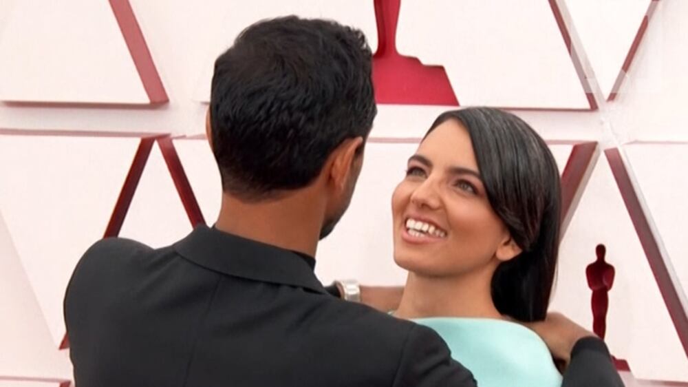 Riz Ahmed turns heads as he fixes his wife's hair on the Oscars red carpet