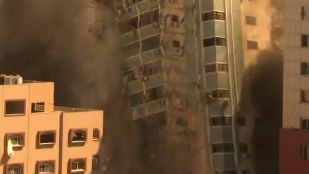 Watch the moment the Gaza media tower collapses after Israeli air strike
