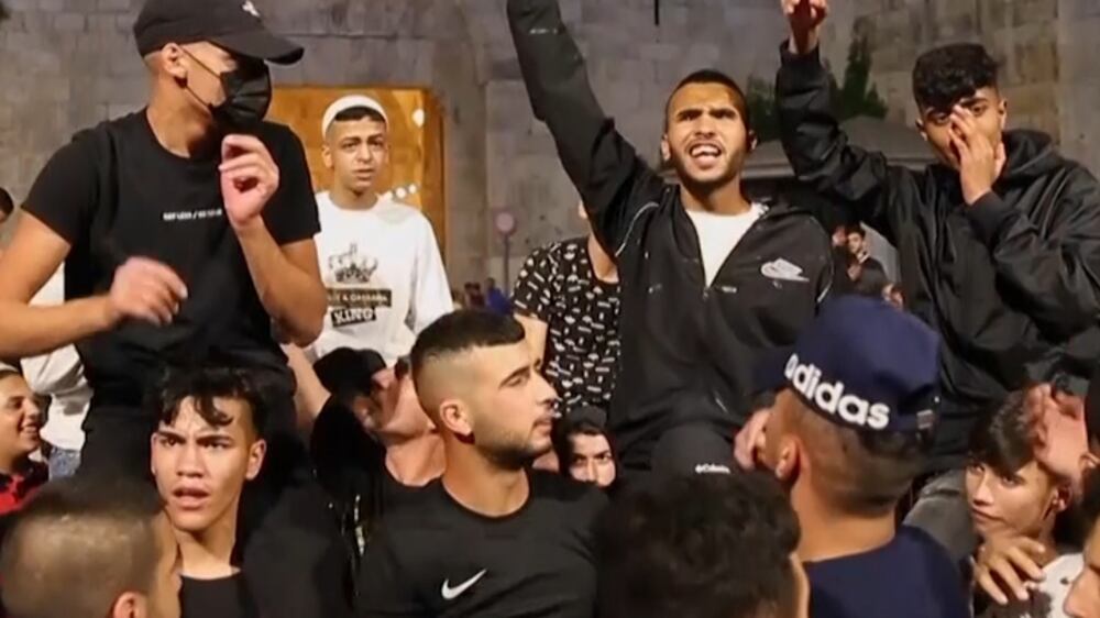 Palestinians celebrate the removal of barricades at entrance to Jerusalem’s Old City