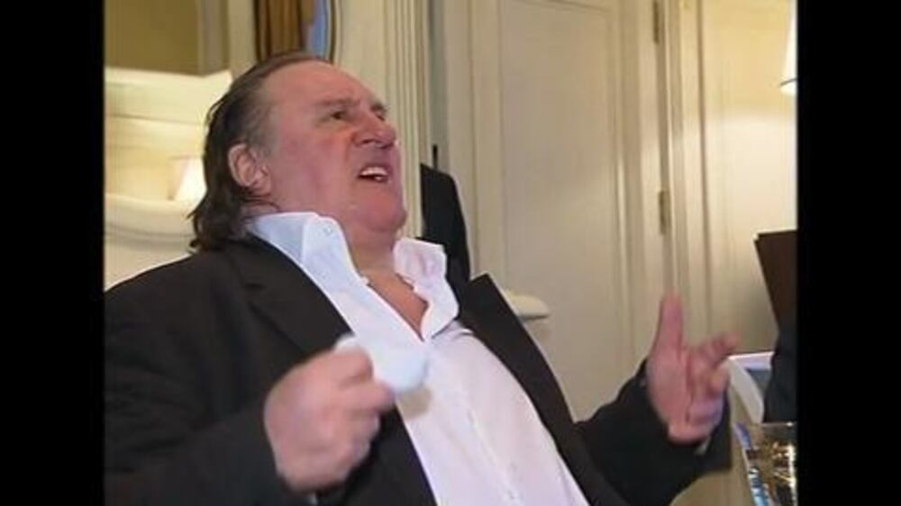 Video: Putin gives Depardieu hug and passport