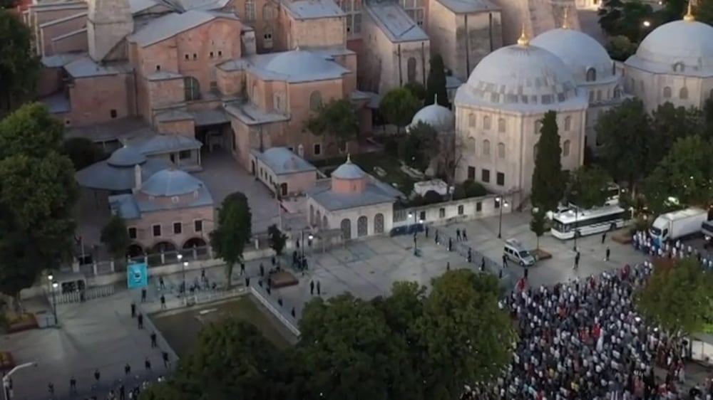 Muslims pray outside the Hagia Sophia after a court ruled on its conversion to a mosque