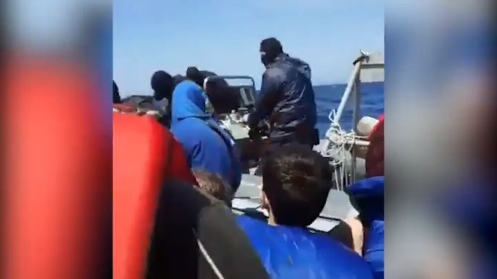 Masked men storm migrant boat